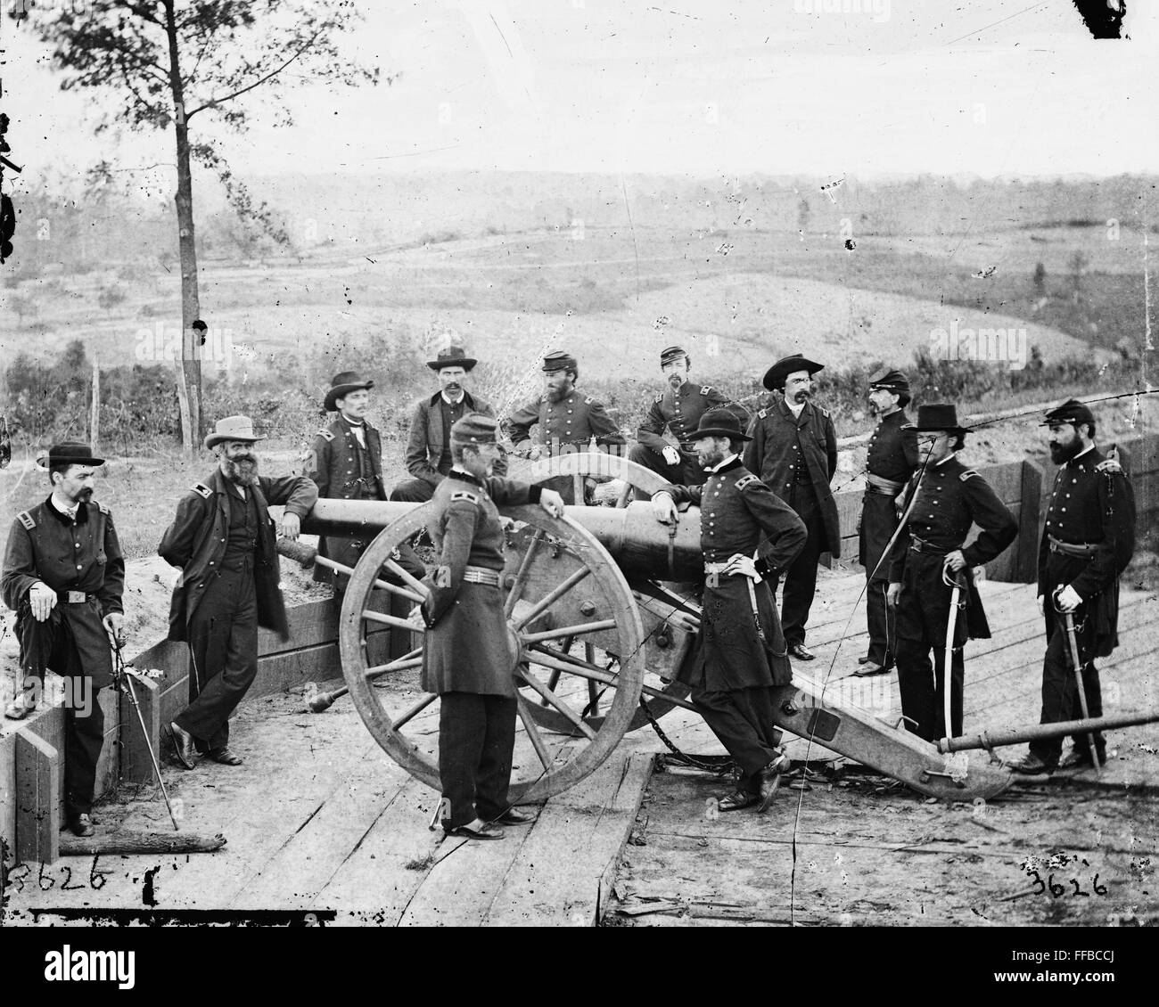 Gen. William T. Sherman, leaning on breach of gun, and staff at Federal Fort No. 7- Atlanta, Ga. .Photograph of the War in the West. These photographs are of Sherman in Atlanta, September-November, 1864. After three and a half months of incessant maneuvering and much hard fighting, Sherman forced Hood to abandon the munitions center of the Confederacy. Sherman remained there, resting his war-worn men and accumulating supplies, for nearly two and a half months. During the occupation, George N. Barnard, official photographer of the Chief Engineer's Office, made the best documentary record. Stock Photo