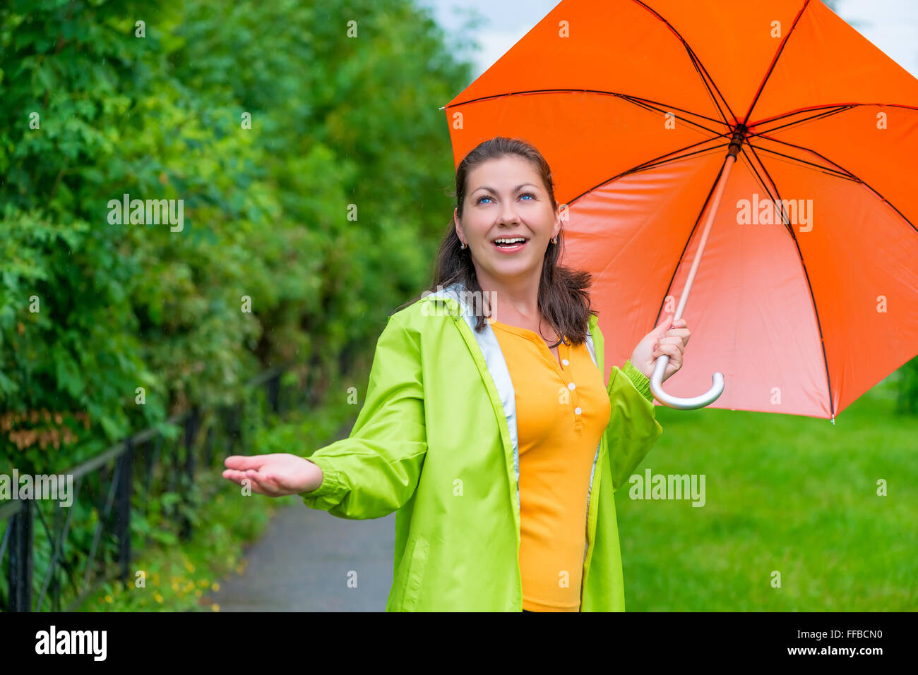 bright girl with an umbrella on a rainy day on the walk Stock Photo - Alamy