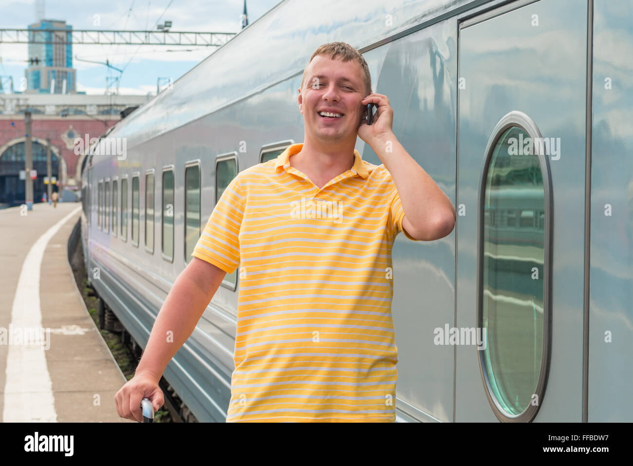 Train Phone Call man talking on the phone in train station Stock Photo - Alamy