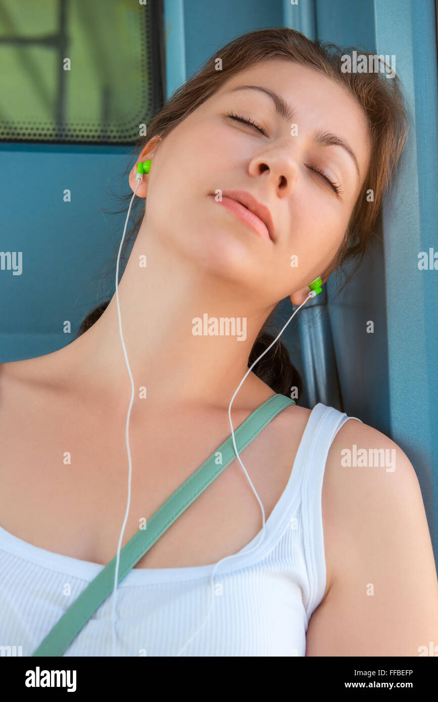 Portrait of a young woman sleeping on public transport Stock Photo