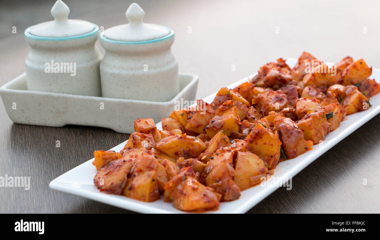Batata saung is a konkani dish in which potatoes are cooked with spicy chilli and tamarind sauce. This can be eaten with rotis o Stock Photo