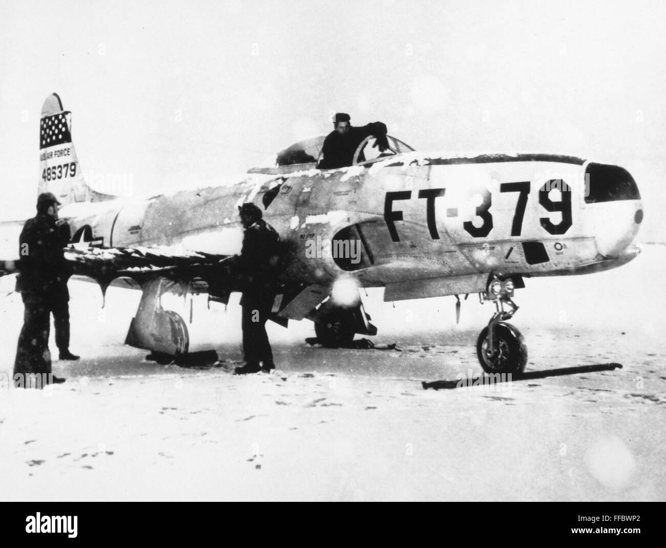 RF-80 'SHOOTING STAR,' 1952. /nGround crewmen of the U.S. Air Force cover an Lockheed RF-80 'Shooting Star' of the 67th Tactical Reconnaissance Wing in a winter storm during the Korean War, 1952. Stock Photo