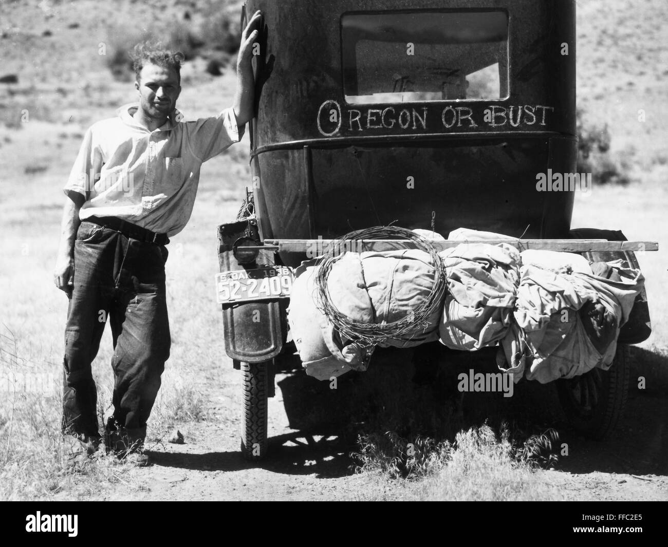 MONTANA: DROUGHT, 1936. /nMan fleeing drought and grasshoppers in South Carolina, with his Model T Ford on Highway 10, Missoula, Montana. Photograph by Arthur Rothstein, 1936. Stock Photo