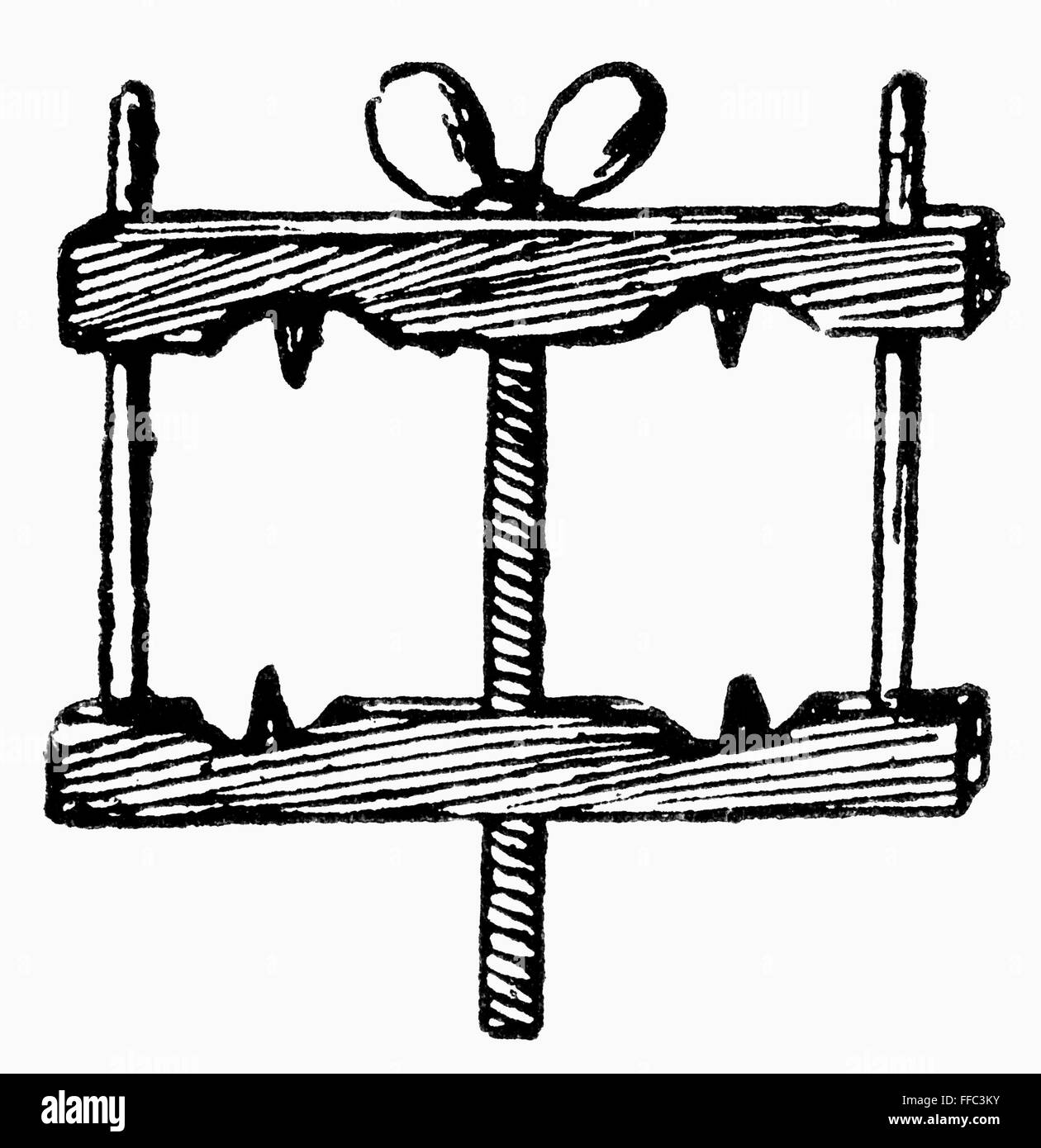 TORTURE INSTRUMENT. /nA medieval thumbscrew. 19th century wood