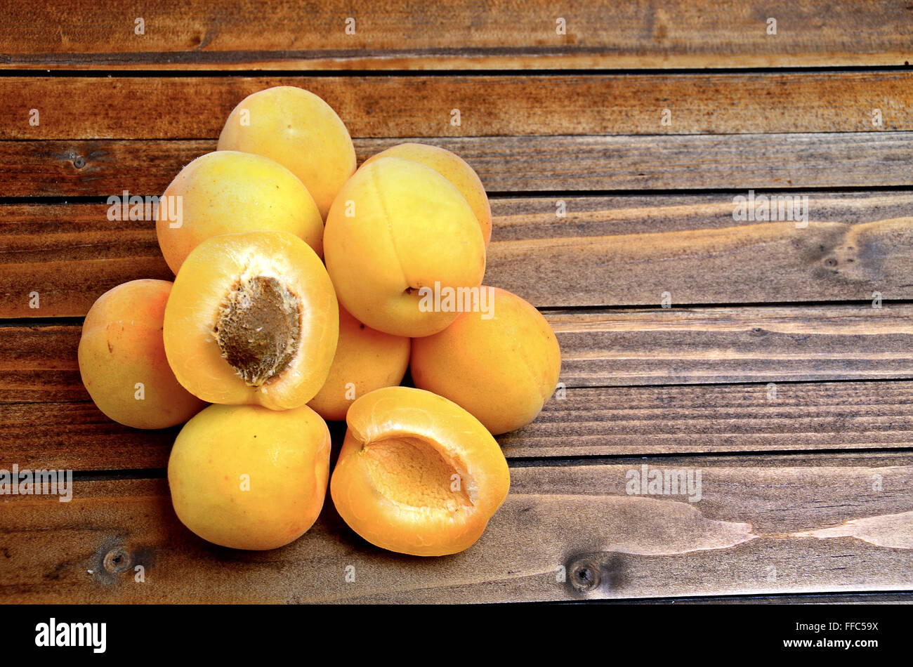 Apricots fruit on wooden table Stock Photo