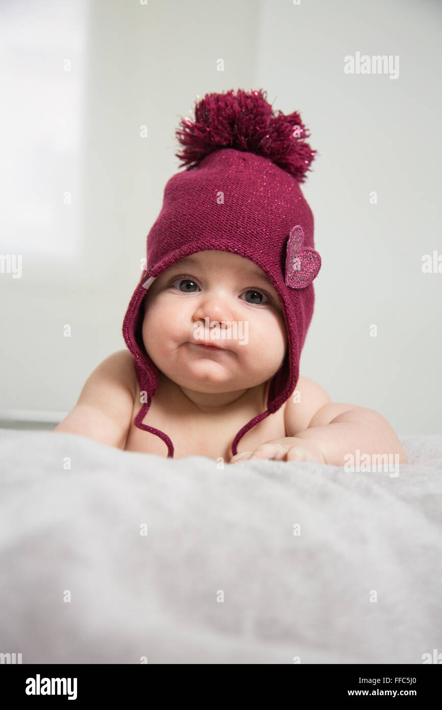 cute baby's portrait with chubby cheek's lying in bed Stock Photo