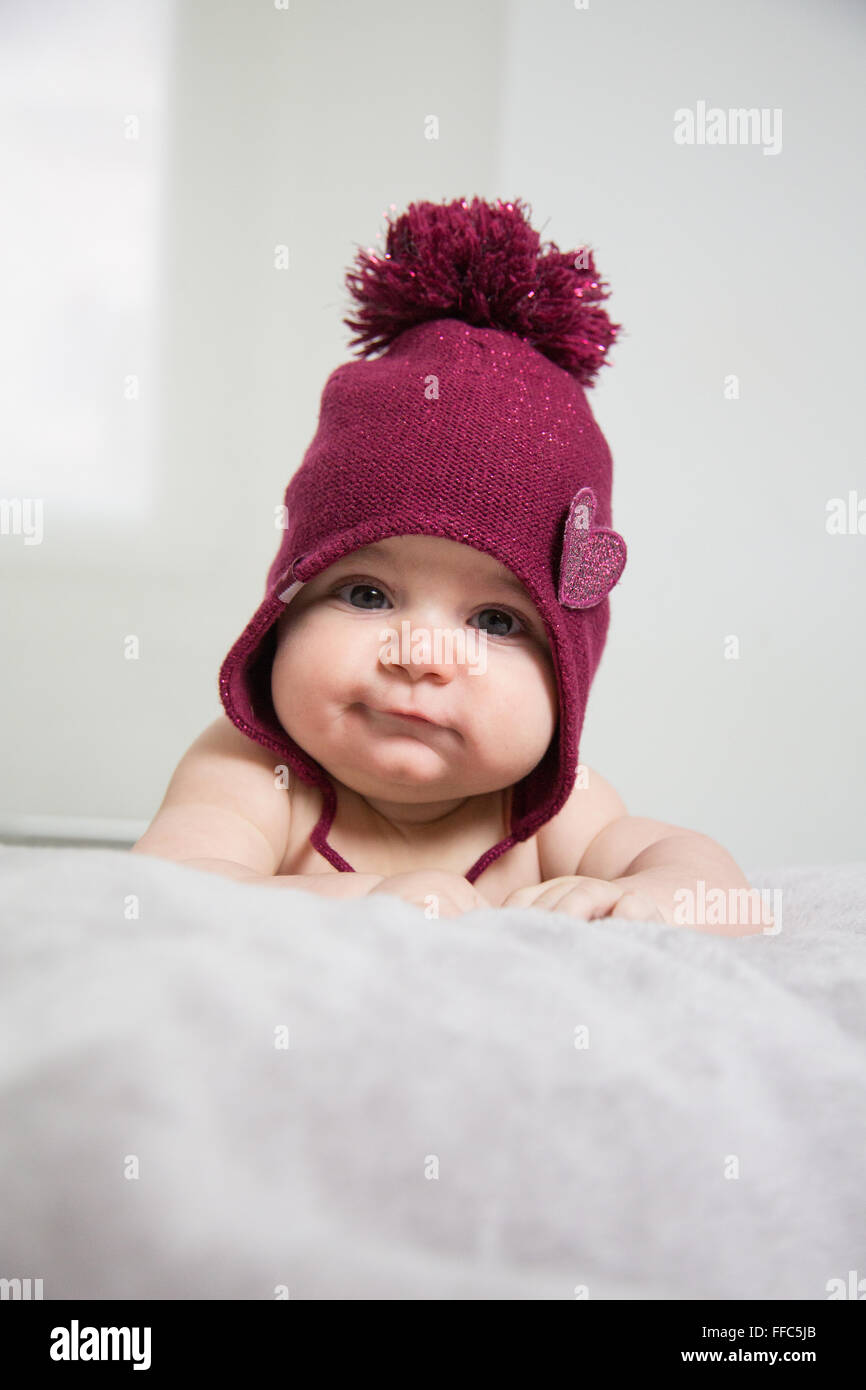 cute baby's portrait with chubby cheek's lying in bed Stock Photo