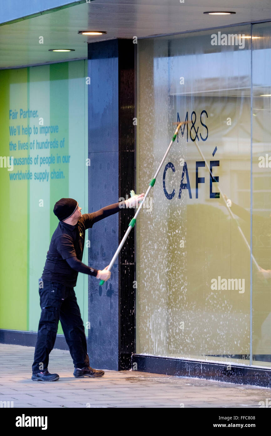A shop window being cleaned in Worthing, UK, 12/02/2016 :  A window cleaner working on a Marks & Spencer shop window. Picture by Julie Edwards Stock Photo