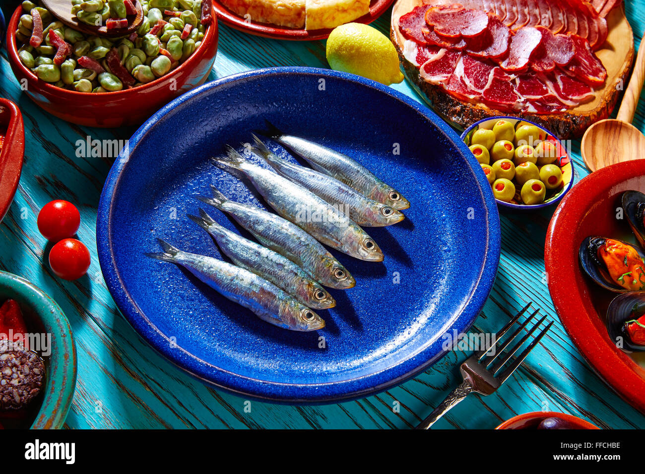 Fish, Spanish tapas - sprat with lemon on baked bread Stock Photo - Alamy