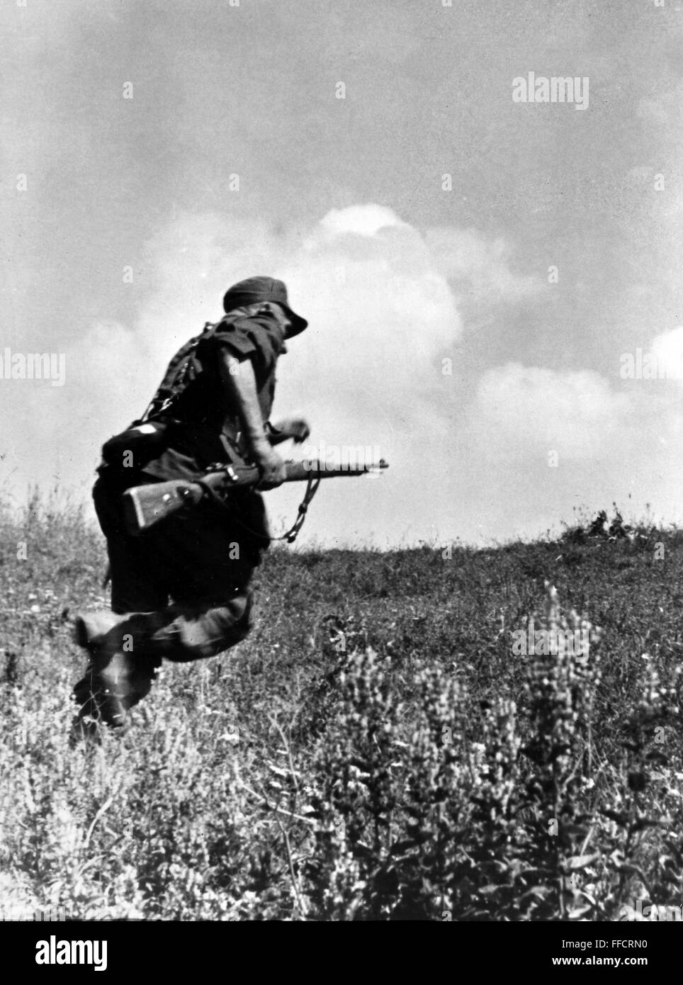 WORLD WAR II: ITALY, 1944. /nGerman mountaineer in Italy being harrassed on patrol by American rifle fire. Photographed October 1944. Stock Photo