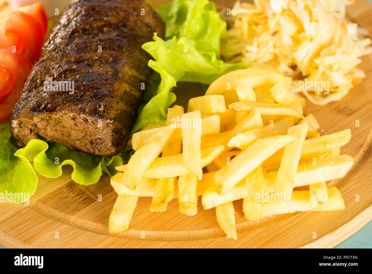 Baked meat, tomatoes and french fries Stock Photo Alamy