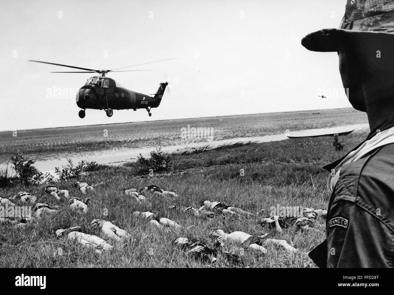 VIETNAM WAR: VIET CONG. /nA helicopter landing near the bodies of Viet Cong, killed in battle with American troops on the Camau Pensinsula, South Vietnam, October 1964. Stock Photo