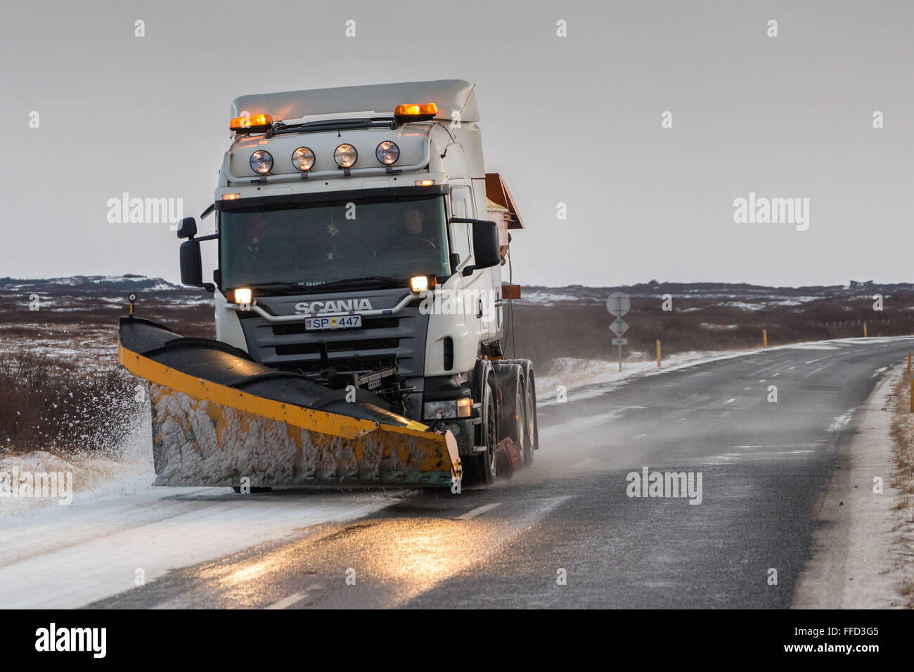 Snowplough clearing a road Stock Photo