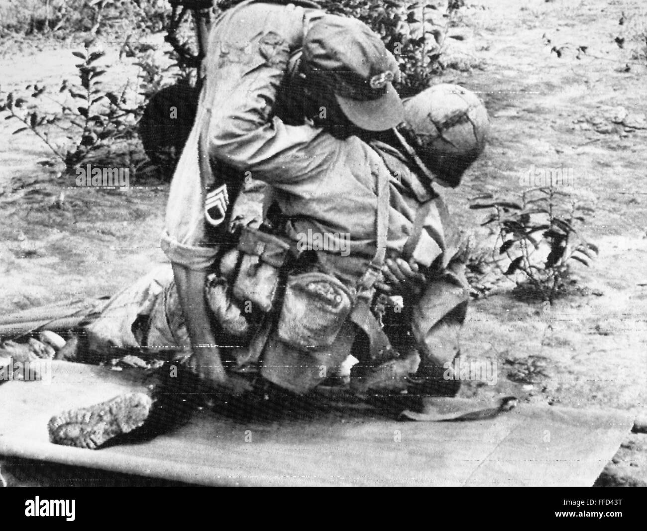 VIETNAM WAR WOUNDED, 1966. /nA medic helps a wounded American soldier
