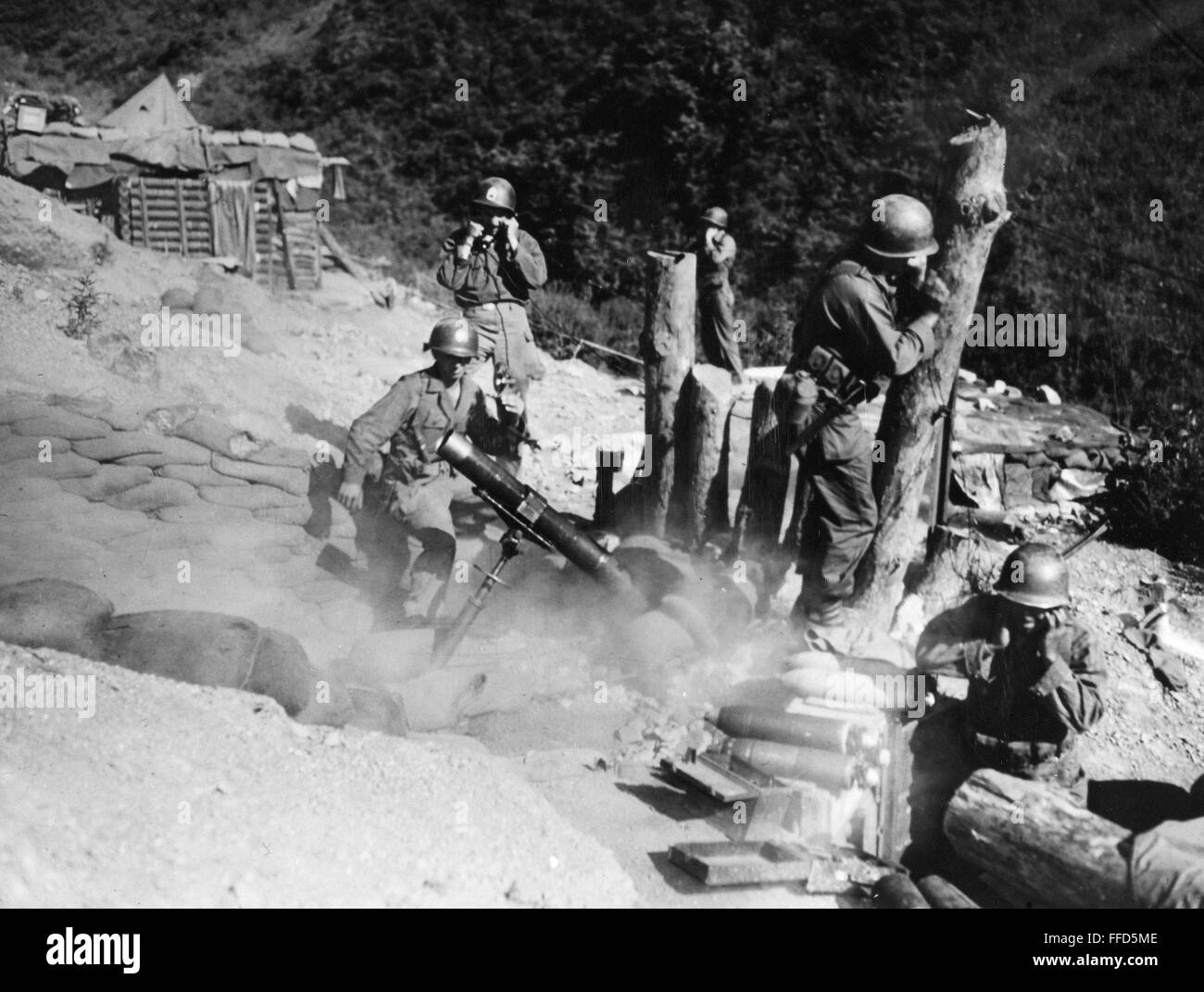 KOREAN WAR: ARTILLERY. /nAmerican soldiers firing a 4.2 inch mortar on the enemy at the Korean front. Stock Photo