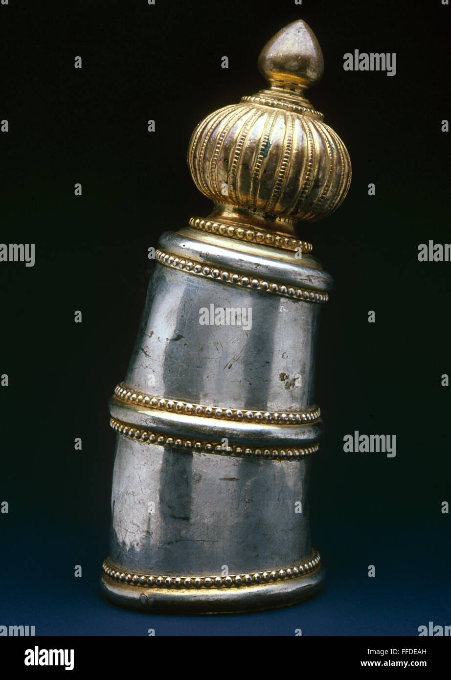 ELEPHANT TUSK ORNAMENT. /nSilver and gold tusk ornament for an elephant