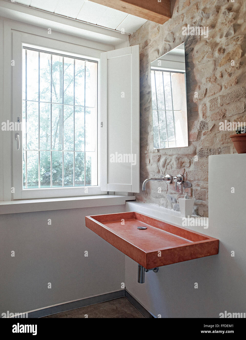 foreground of washbasin n the bathroom with a stone wall Stock Photo