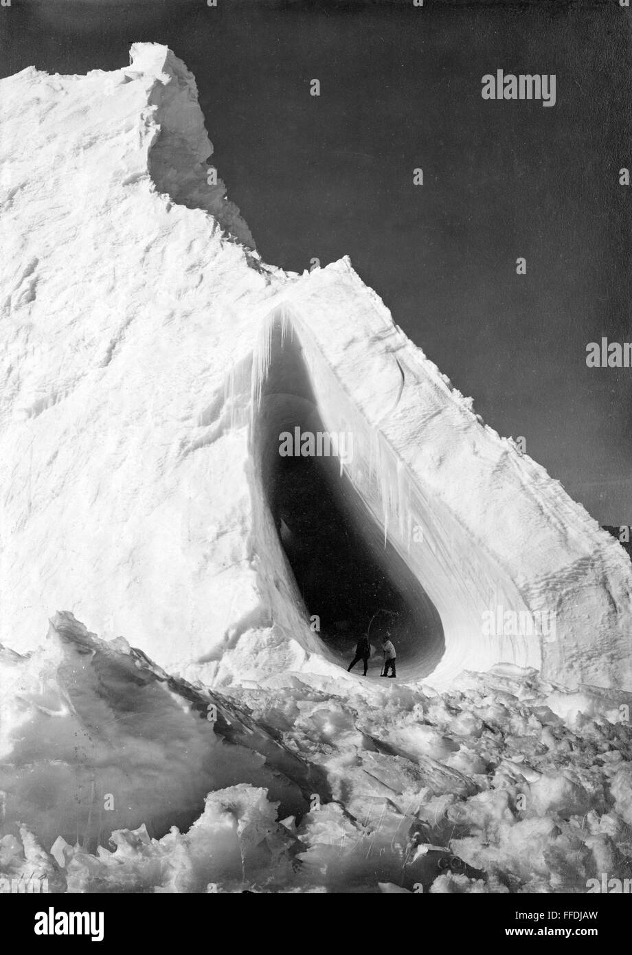 TERRA NOVA EXPEDITION. /nTwo men in the opening of Grotto Iceberg in Antarctica, during Robert Falcon Scott's 'Terra Nova' expedition to the South Pole, 1910-1912. Photograph by Herbert Ponting. Stock Photo
