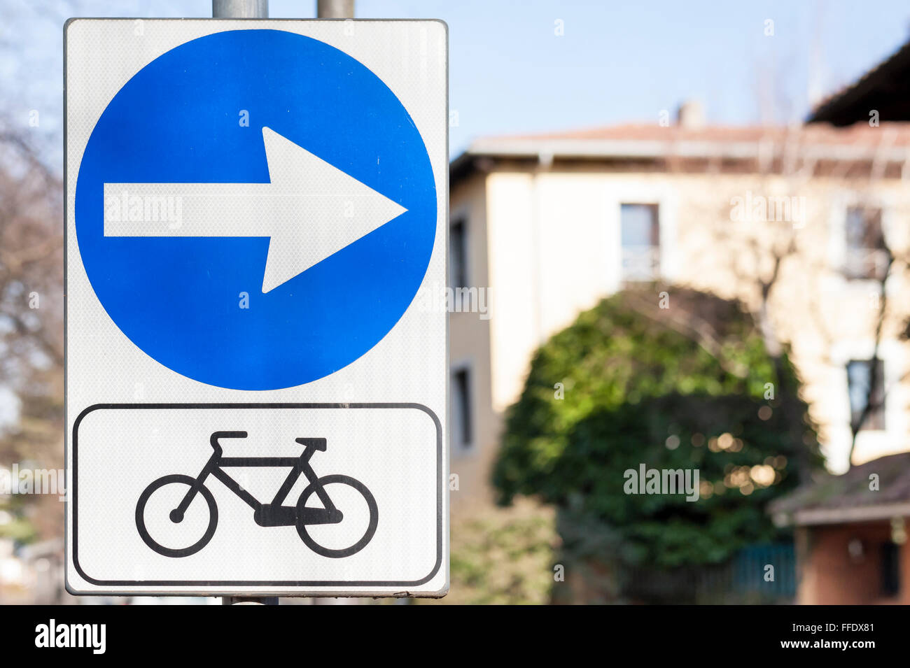 Road sign indicating the direction of the bike path. Stock Photo
