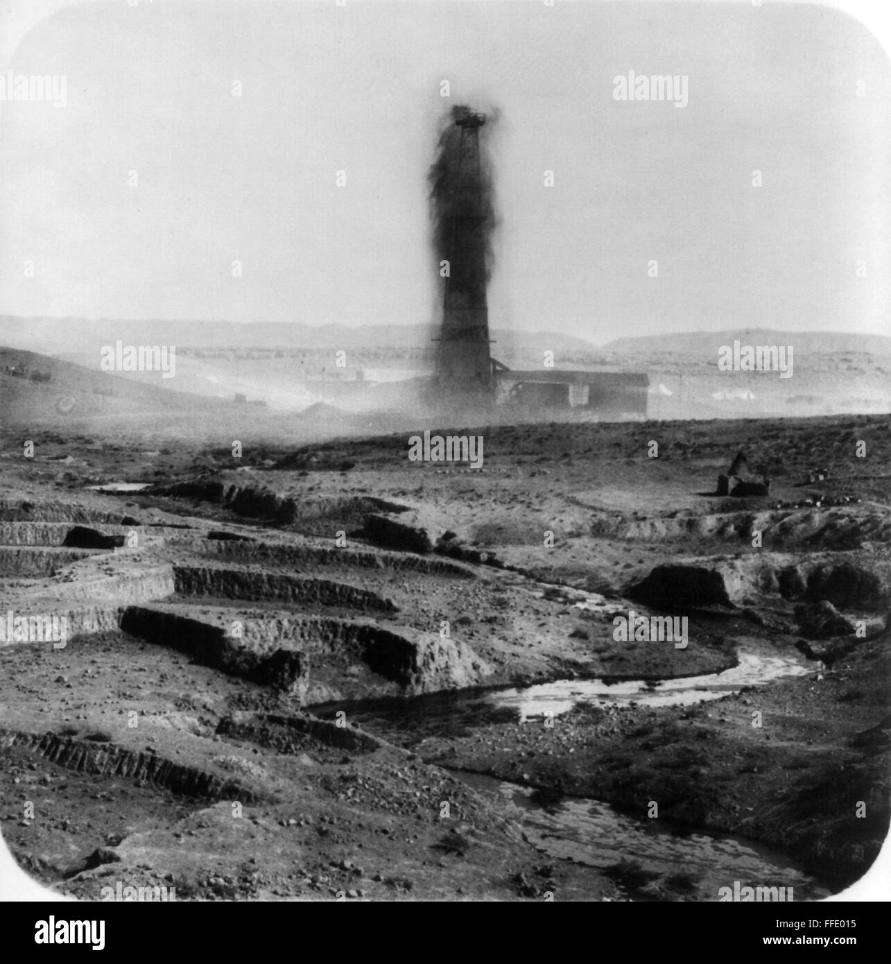 IRAQ: OIL WELL, 1930s. /nGushing oil well and a stream of oil in the foreground, Kirkuk, Iraq, 1932-33. Stock Photo