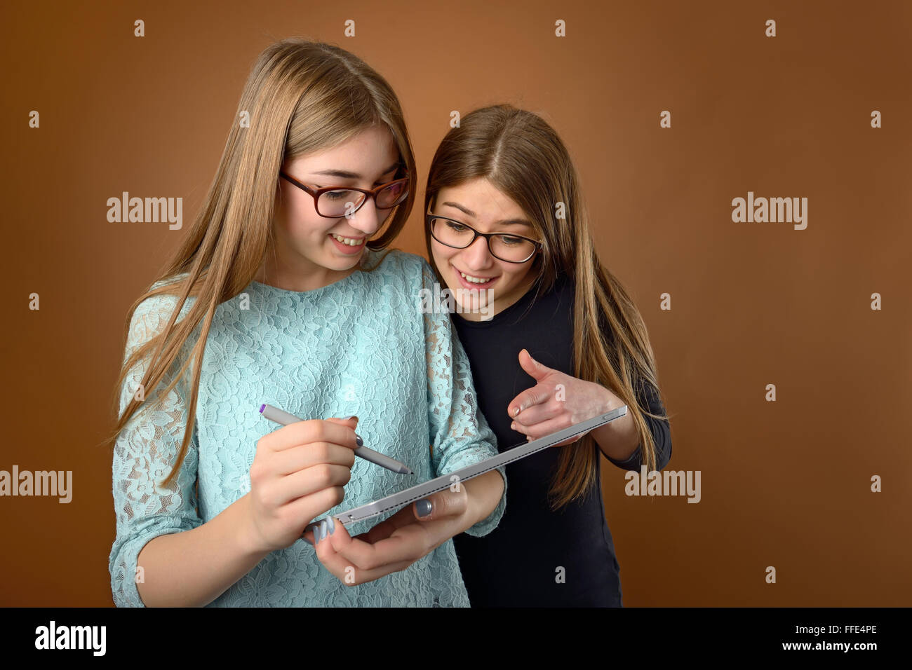 Two teen young friends using a computer tablet Stock Photo
