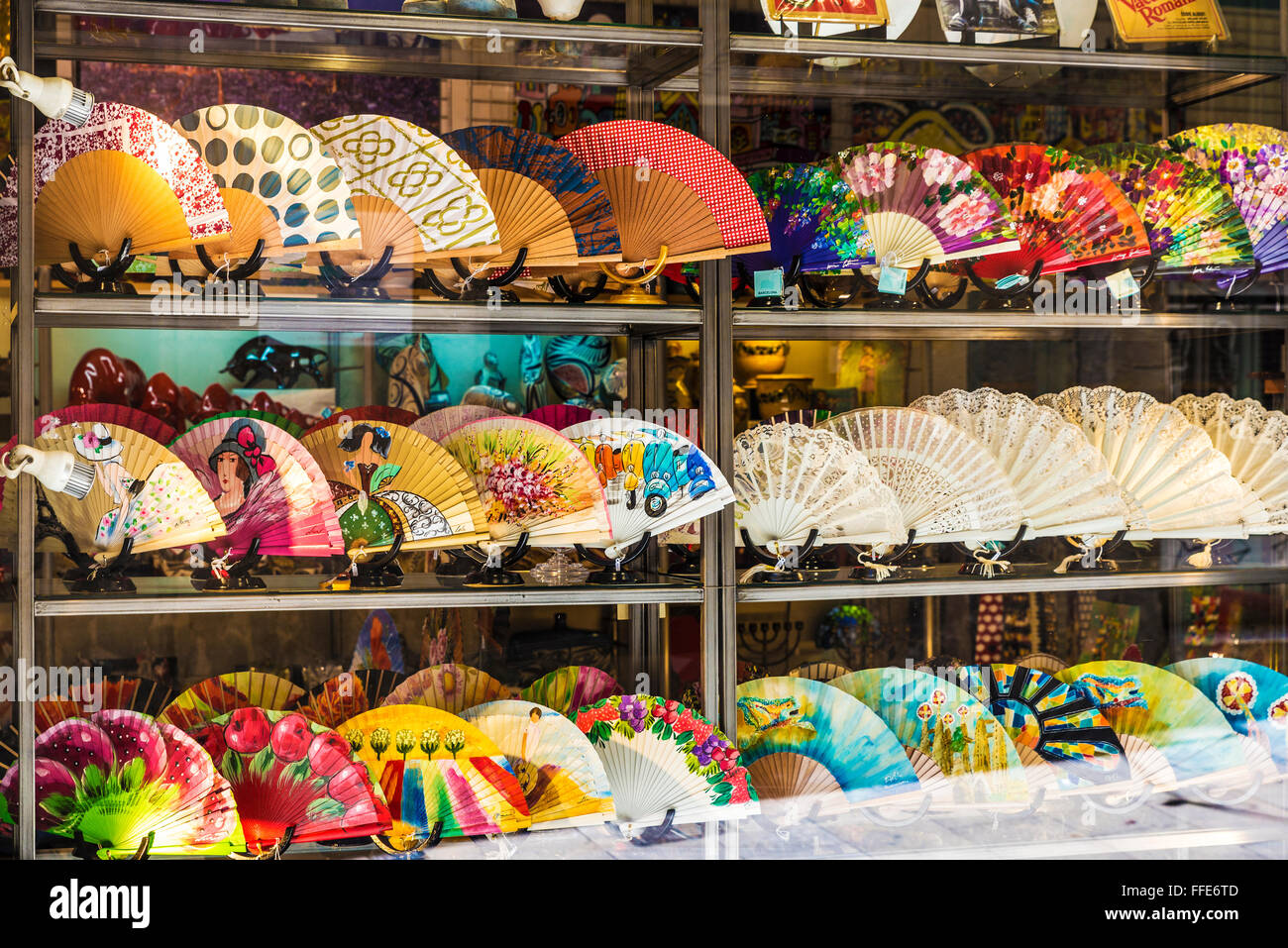 Window of a souvenir shop full of fans on a street of the Gothic