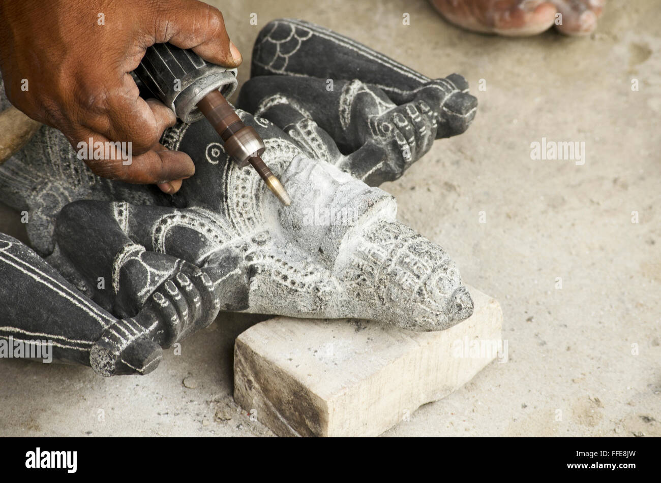 Artist giving finishing touches to a sculpture in Mahabalipuram, Tamil Nadu, India, Asia Stock Photo