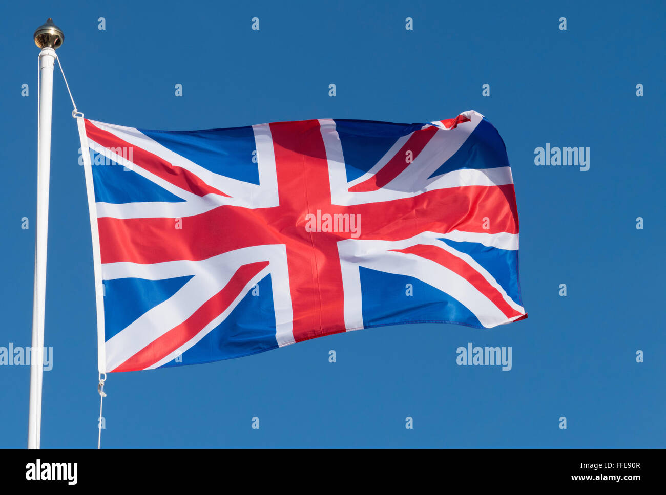 UK Union Jack Flag of Great Britain blowing in the wind. Stock Photo