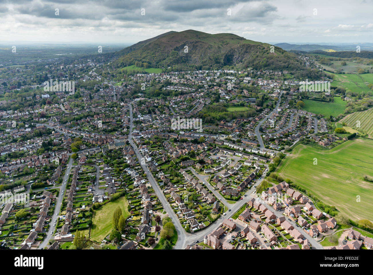An aerial view of Great Malvern with the Malvern Hills visible under a looming grey sky Stock Photo