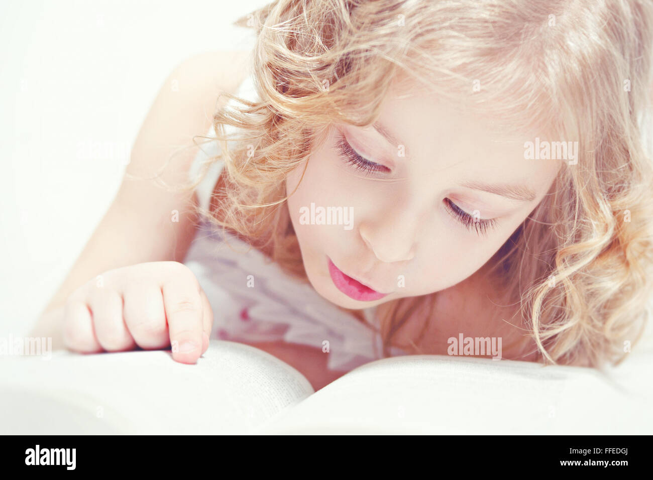 Portrait of little adorable girl with a book Stock Photo - Alamy