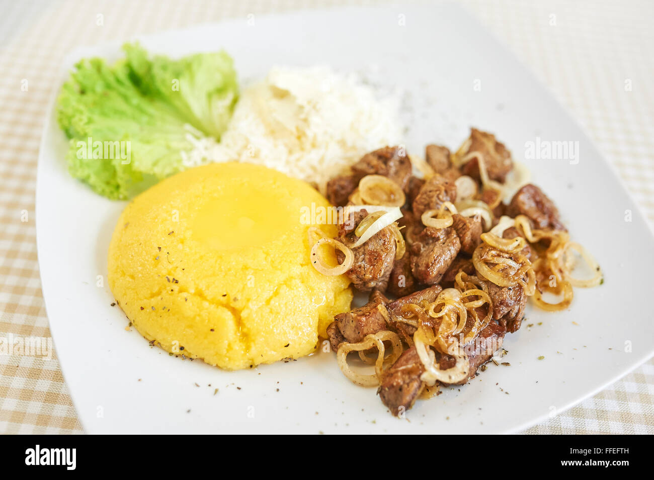 Mamaliga With Cottage Cheese and Pork and Lettuce Stock Photo