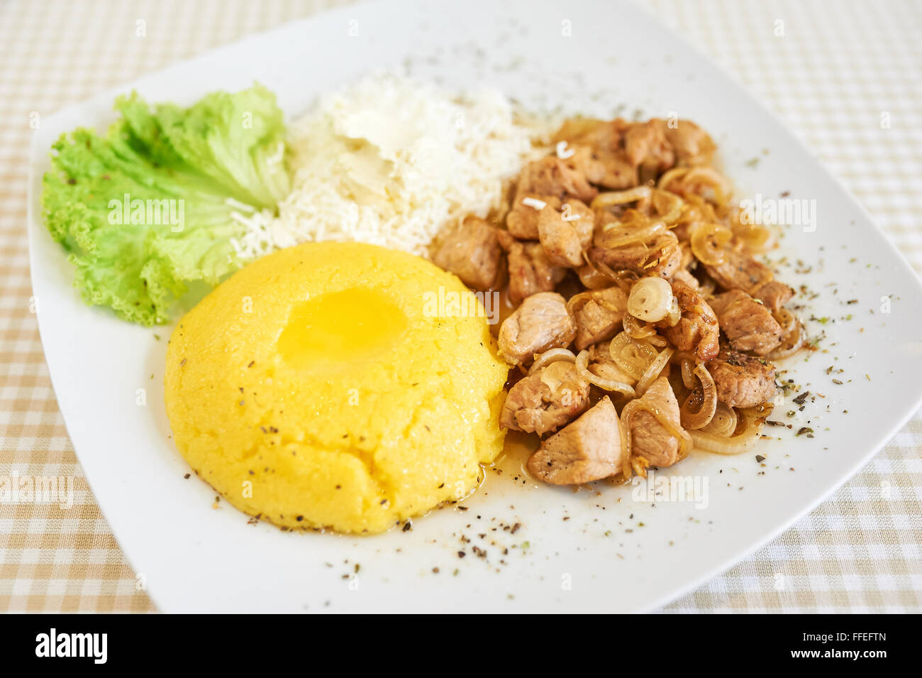 Mamaliga With Cottage Cheese and Pork and Lettuce Stock Photo