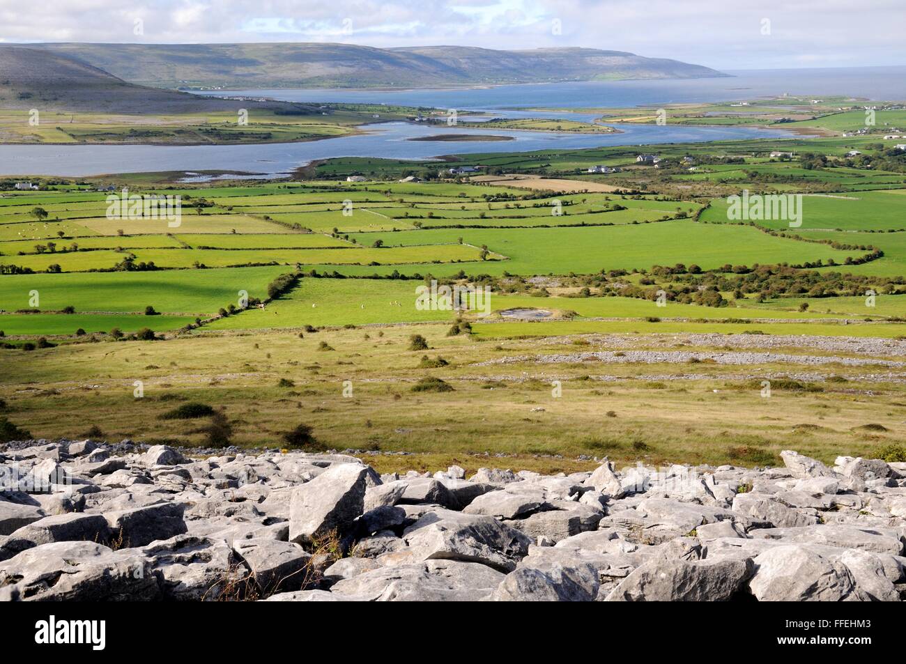 karst landscape and green fields from Abbey Hill towards Galway Bay The Burren County Clare Ireland Stock Photo