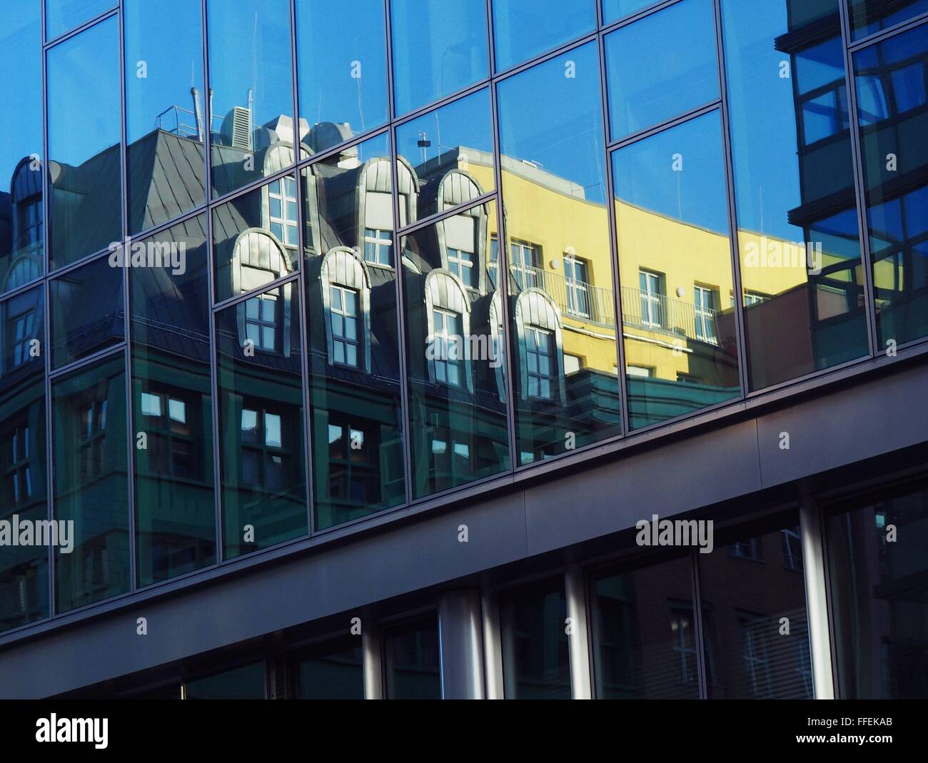 Buildings with flats and offices are reflected in windows of an office building in the center of Berlin on December, 21, 2015. Photo: Wolfram Steinberg/dpa Stock Photo
