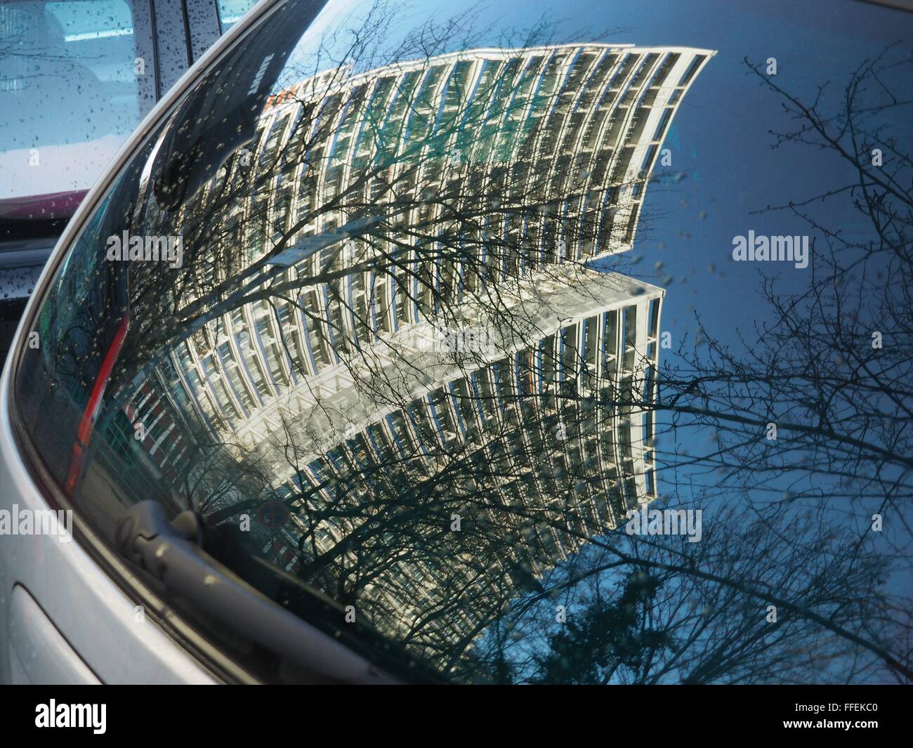 Old high buildings with flats are reflected in the window of a car in the former East German part of the city in the center of Berlin on December 21, 2015. Photo: Wolfram Steinberg/dpa Stock Photo