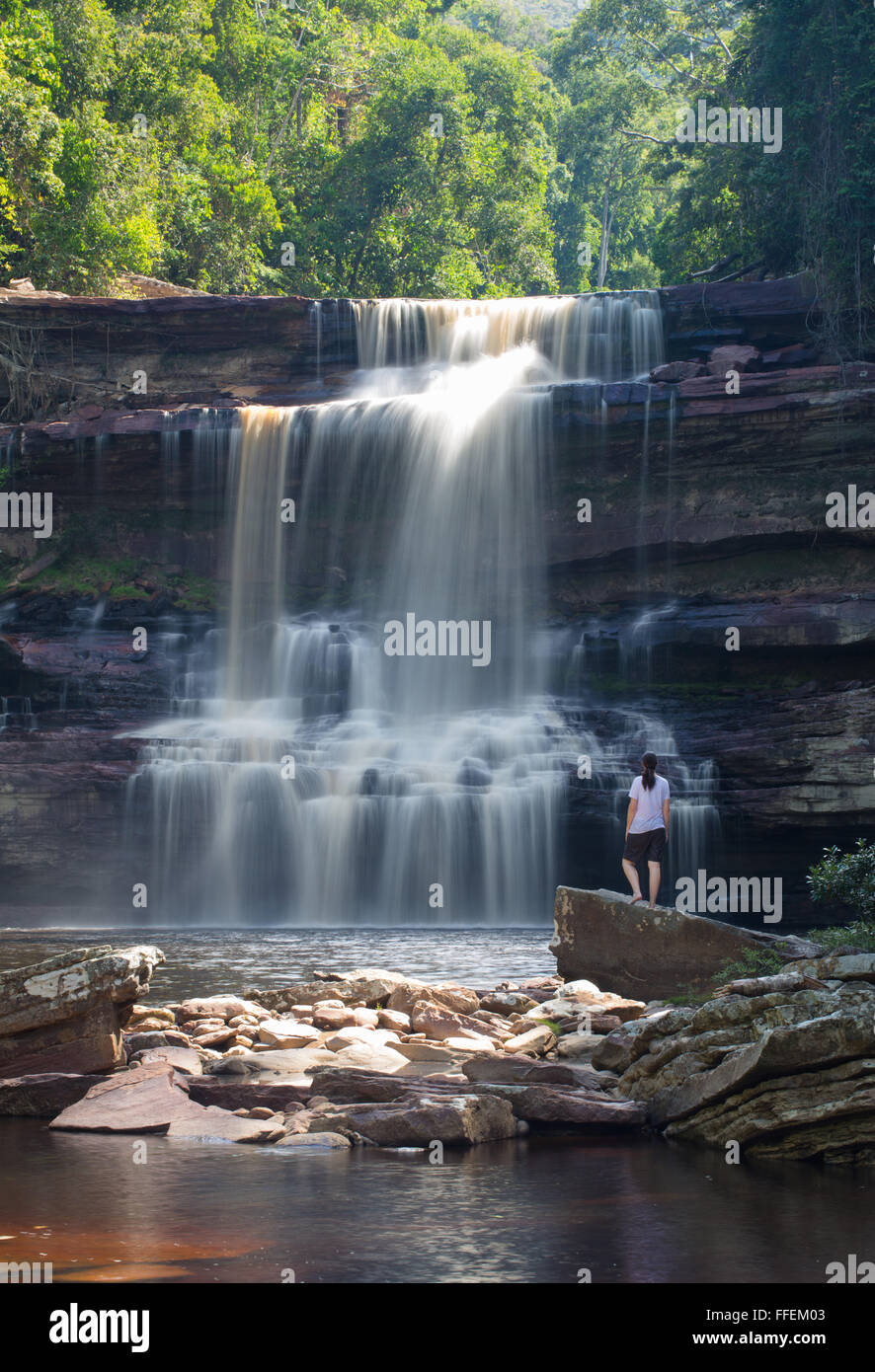 Woman standing in front of Maliau Falls in the Maliau Basin, Sabah, Malaysia Stock Photo