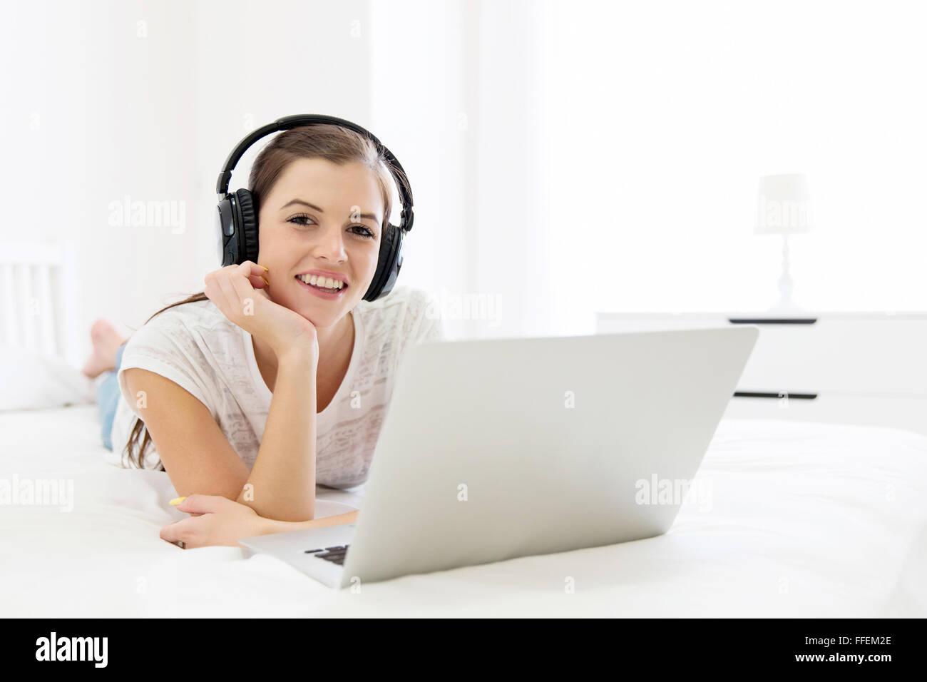 beautiful young woman watching a movie on laptop Stock Photo