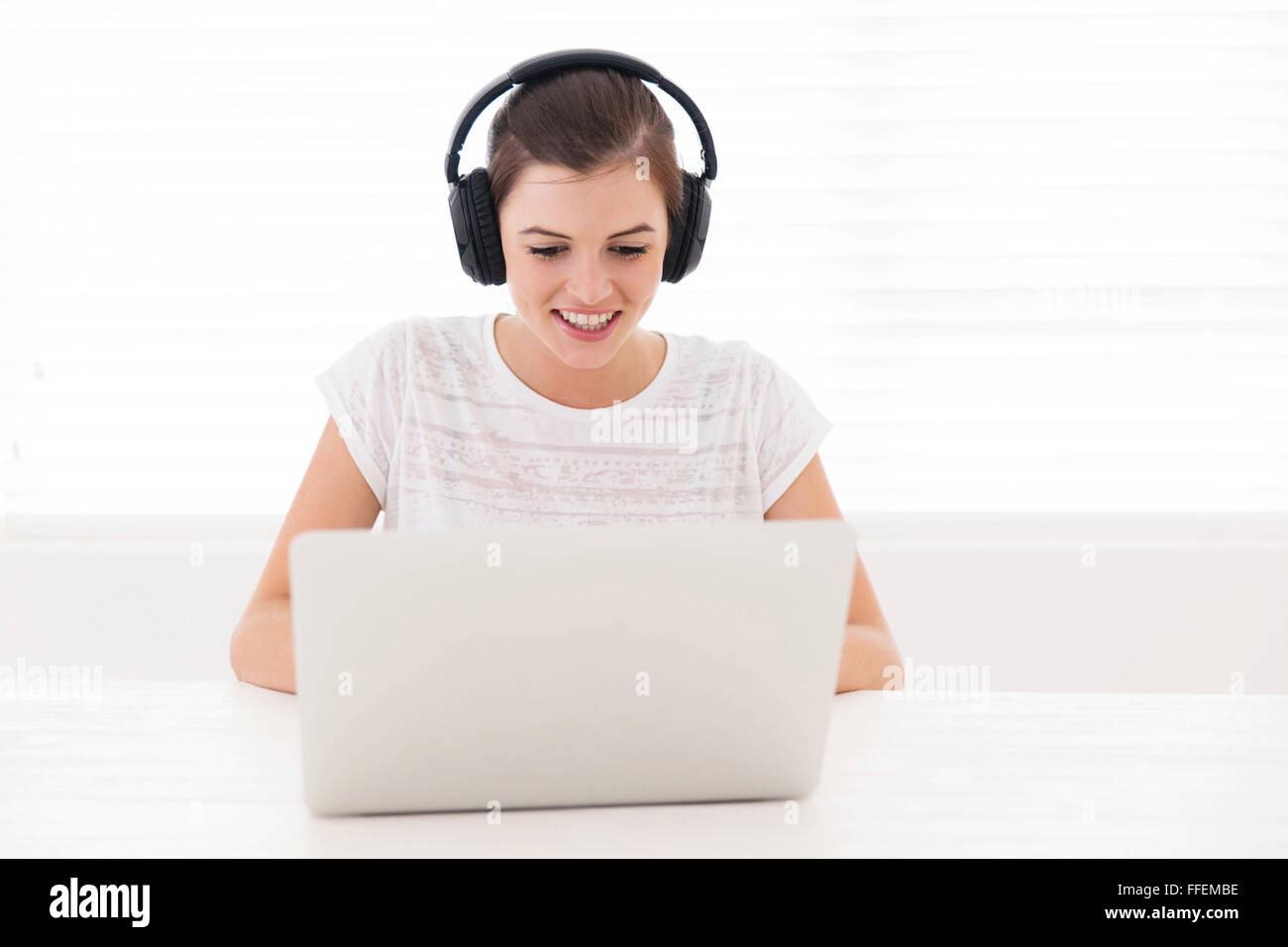 happy teen girl watching a movie on laptop Stock Photo