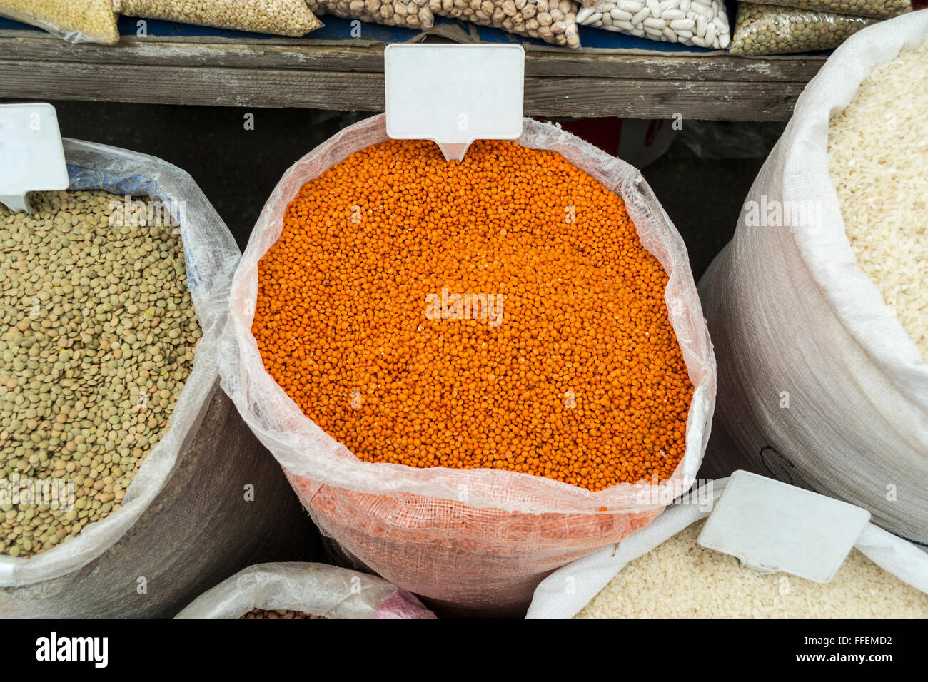 Sacks of vegetables in open market with banners Stock Photo Alamy