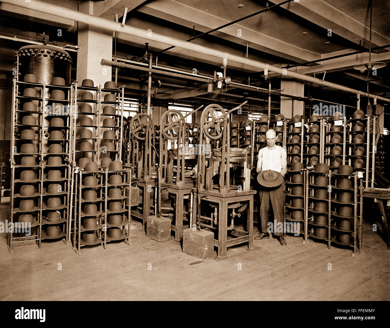 Hats manufactured for American soldiers by John B. Stetson Co., Phila., Pa.  Pressing Army service hats.  Ca.  1917-18. Stock Photo