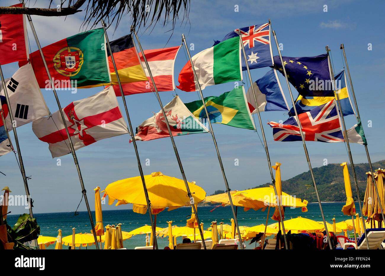 Phuket, Thailand :   Colourful flags of many nations, mostly European, fly over sandy Patong Beach Stock Photo