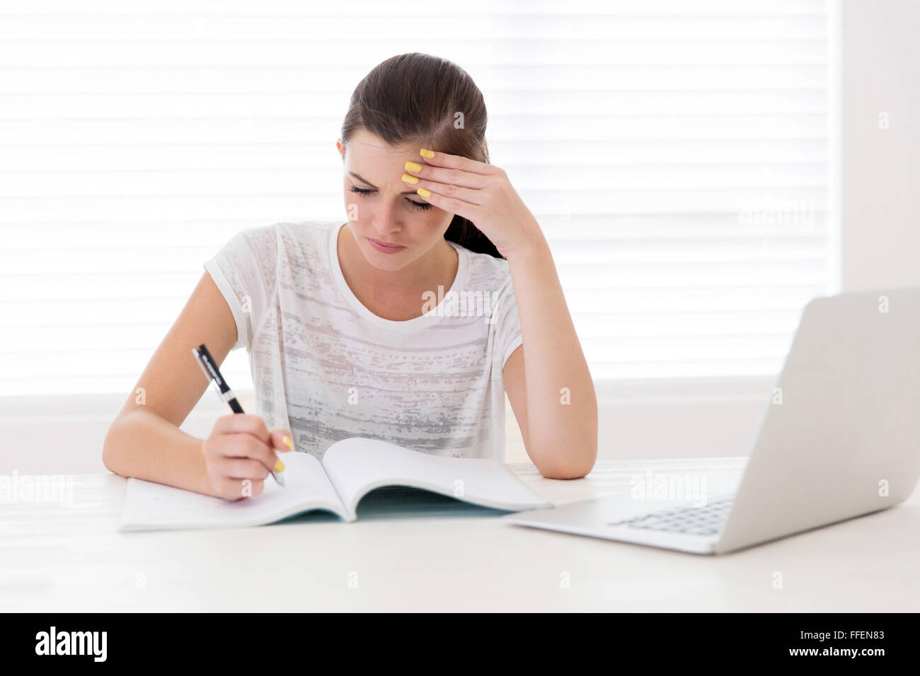 struggling teen girl studying at home Stock Photo