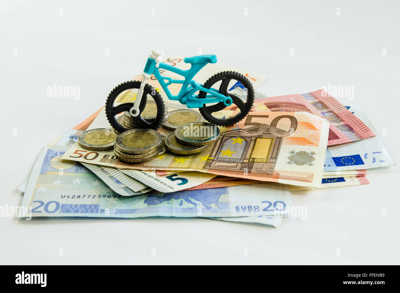 toy bicycle, banknotes and coins Stock Photo