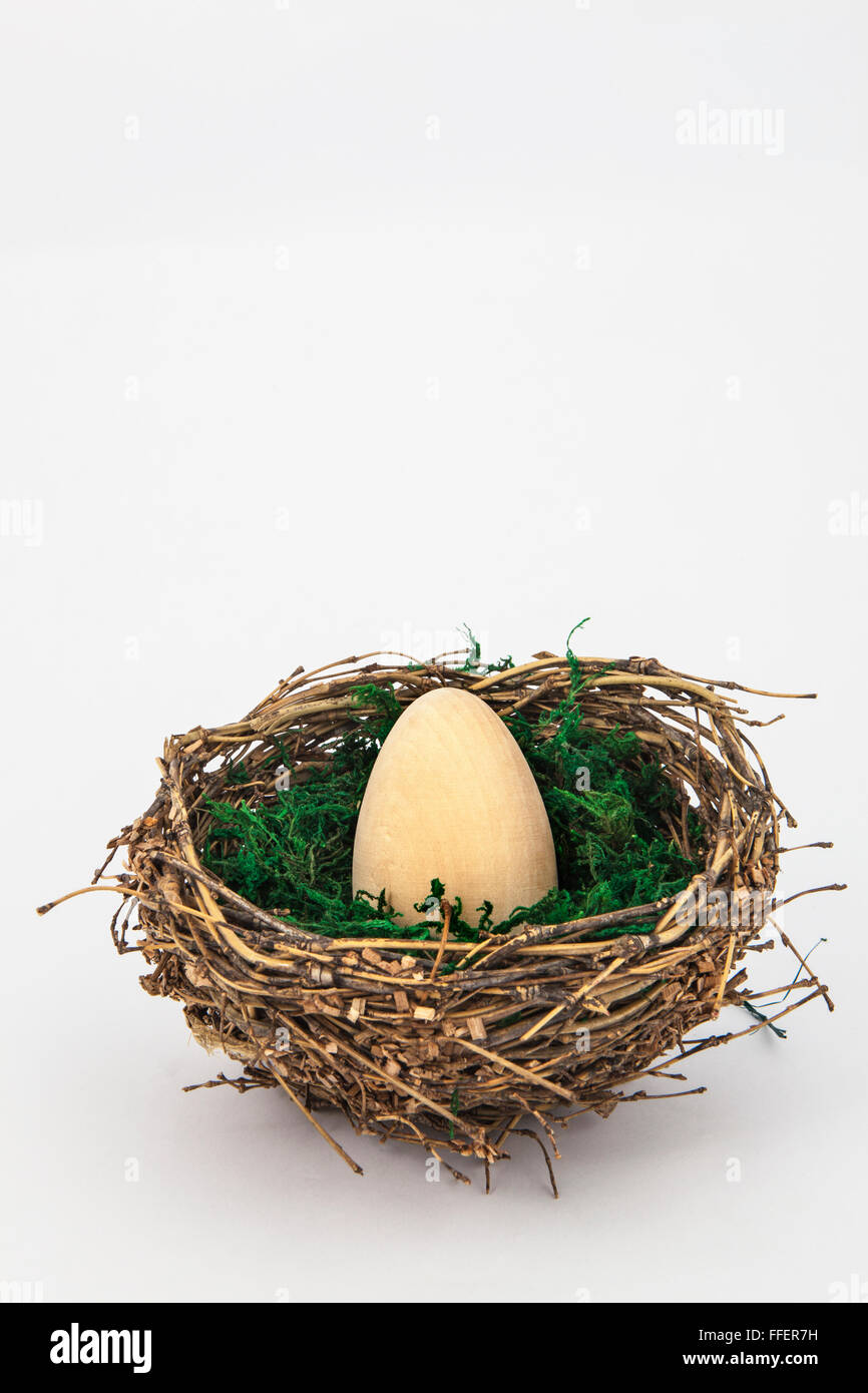 Easter wooden egg on nest Stock Photo - Alamy
