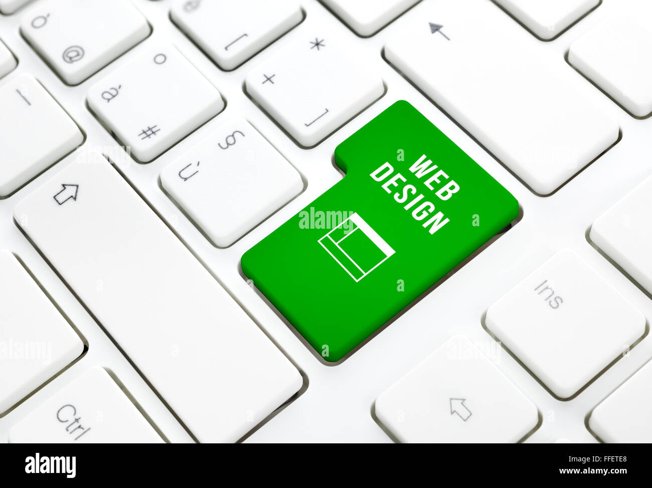 Web Design business concept, green enter button or key on white keyboard photography. Stock Photo
