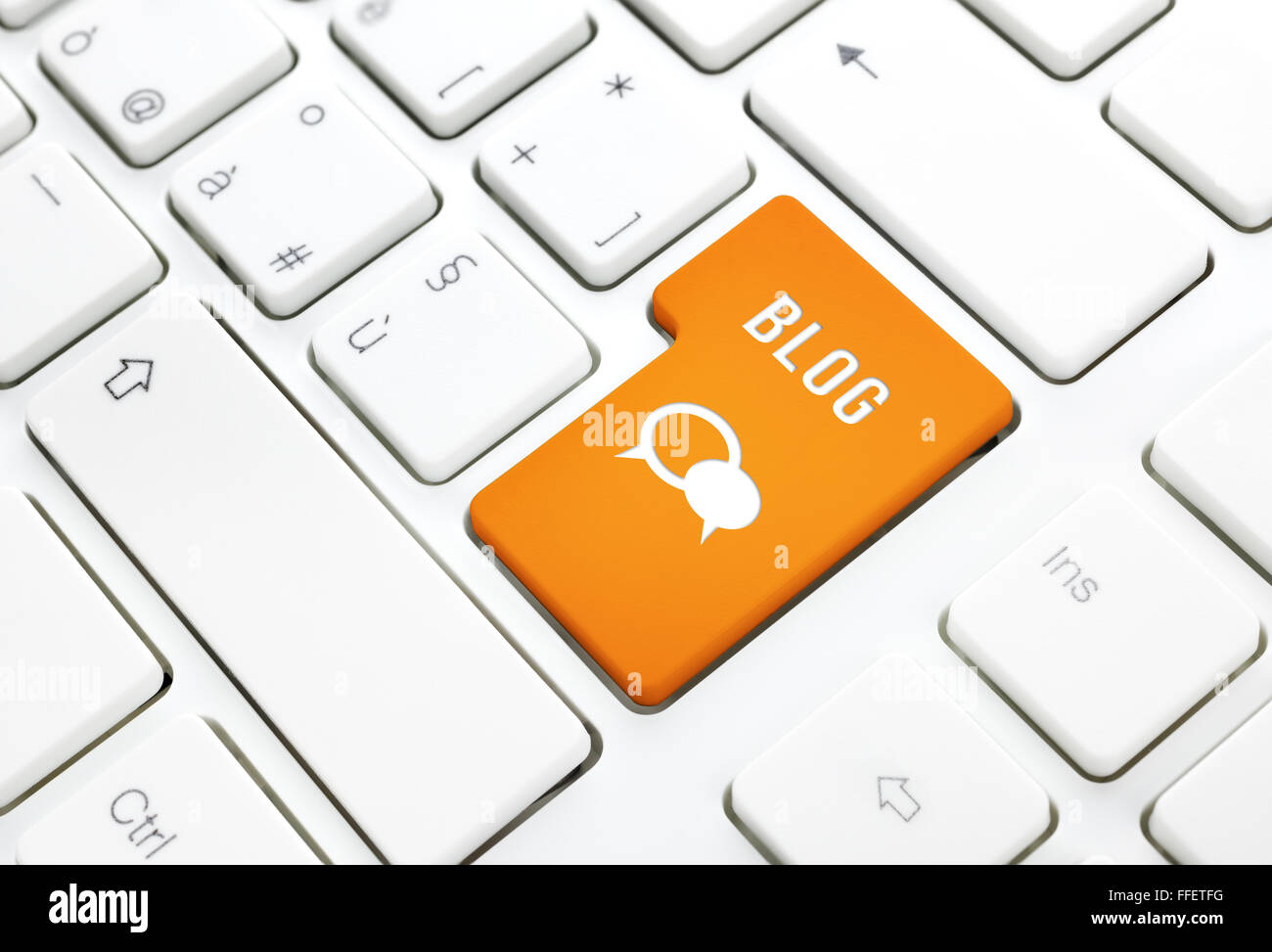 Blog business concept, text and icon. Orange enter button or key on white keyboard photography. Stock Photo