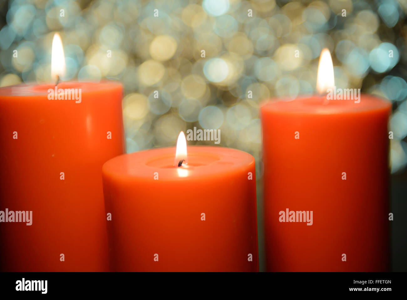 three big aromatic candle light up in front of beautiful bokeh background, valentine's day Stock Photo