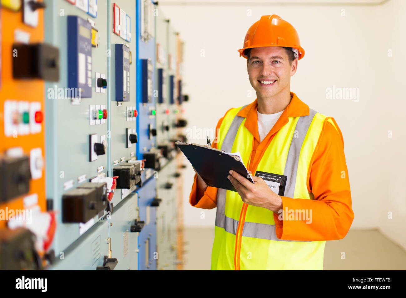 happy young industrial engineer taking machine readings Stock Photo