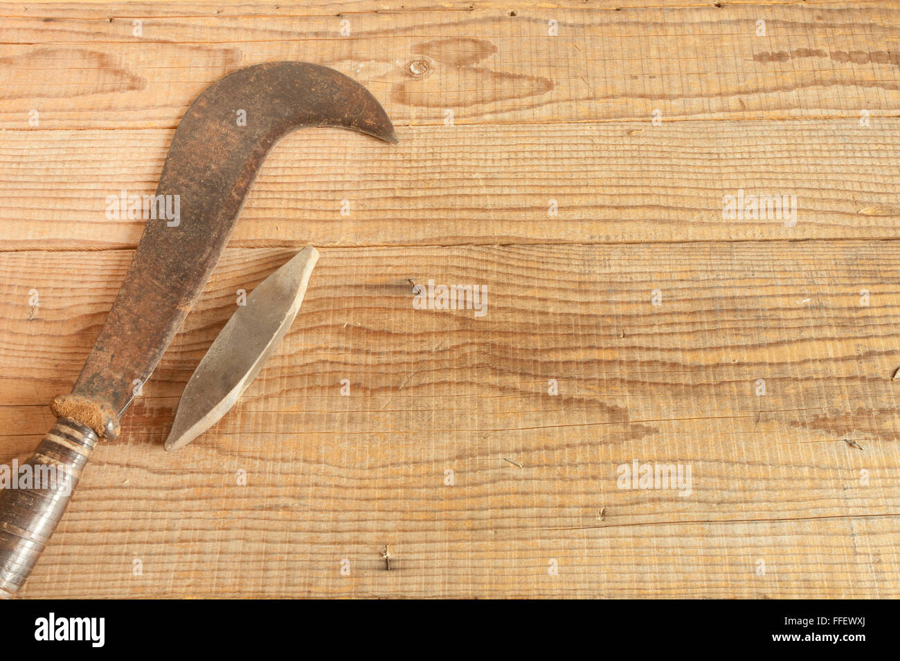 dated and used billhooks on wooden background Stock Photo