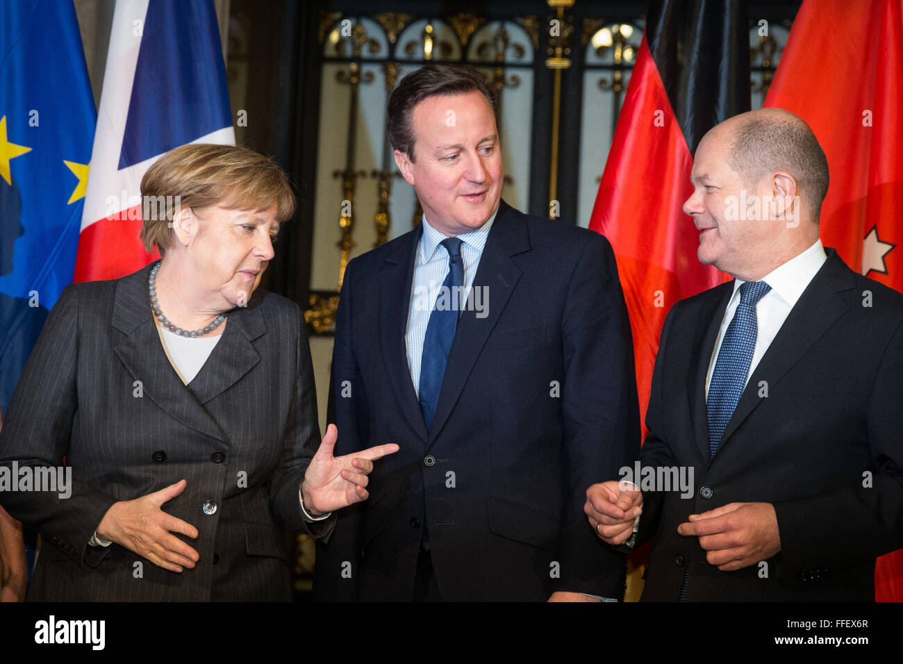 Hamburg, Germany. 12th Feb, 2016. Chancellor Angela Merkel (CDU, l), British Premier David Cameron (c) and Mayor of Hamburg Olaf Scholz (SPD, r) together at the city hall of Hamburg, Germany, 12 February 2016. Merkel and Cameron are guests of honour at the oldest feast in the world. Since 1356, the governance of the Hanse city invites to the Matthiae dinner. PHOTO: CHRISTIAN CHARISIUS/dpa/Alamy Live News Stock Photo